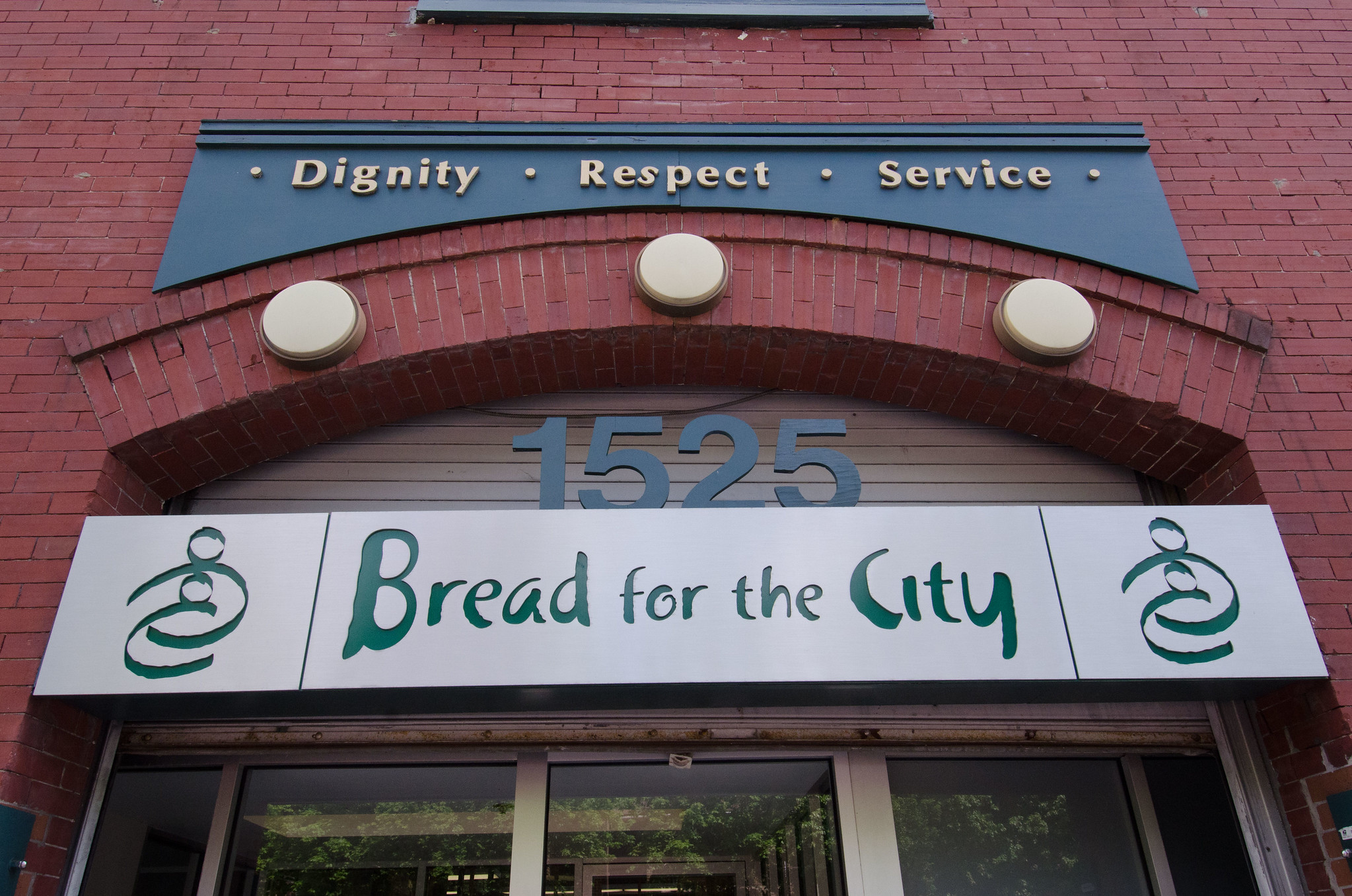 The front facade of a building with a sign that reads "Bread for the City"