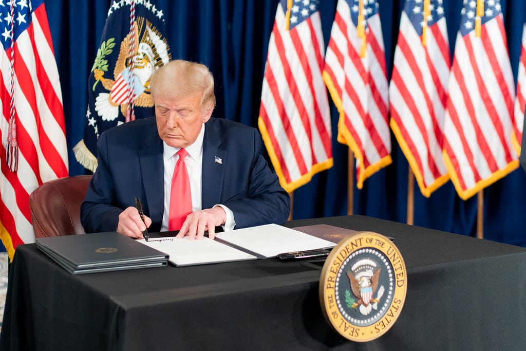 Photo of Trump signing a memorandum