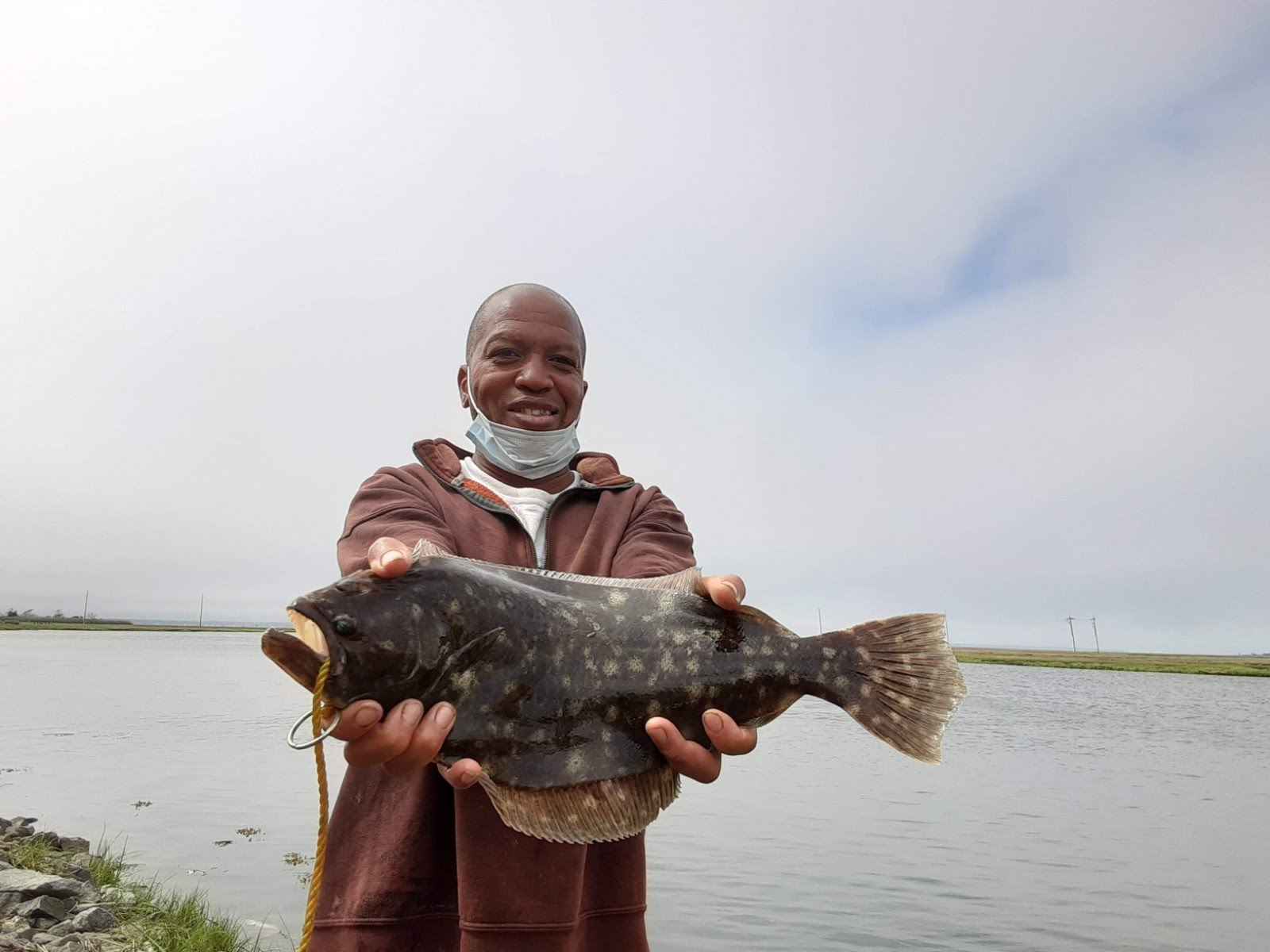 Photo of Jeffery McNeil holding a fish.