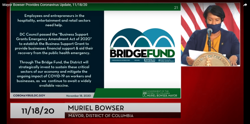 A screenshot from Mayor Bowser's video broadcast on Nov. 18, showing her speaking next to a slide about the Bridge Fund.