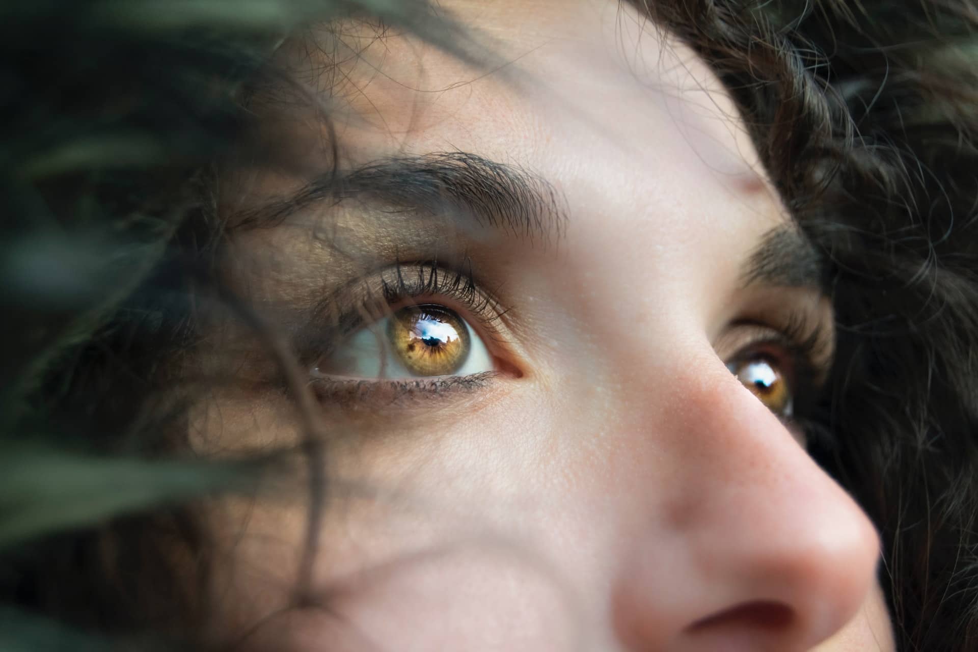 A brown-eyes woman looks up.