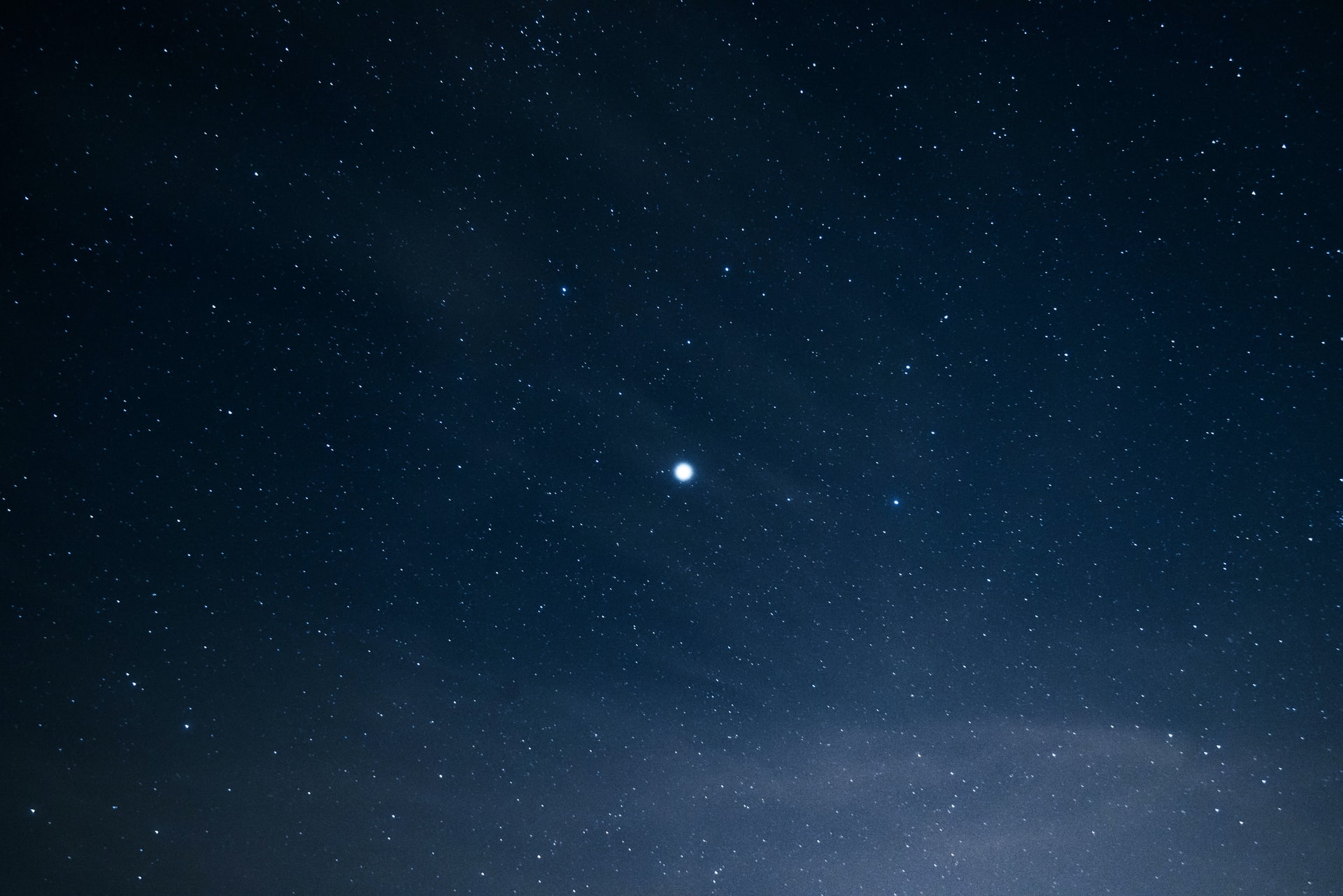 One bright star in a starry night sky.