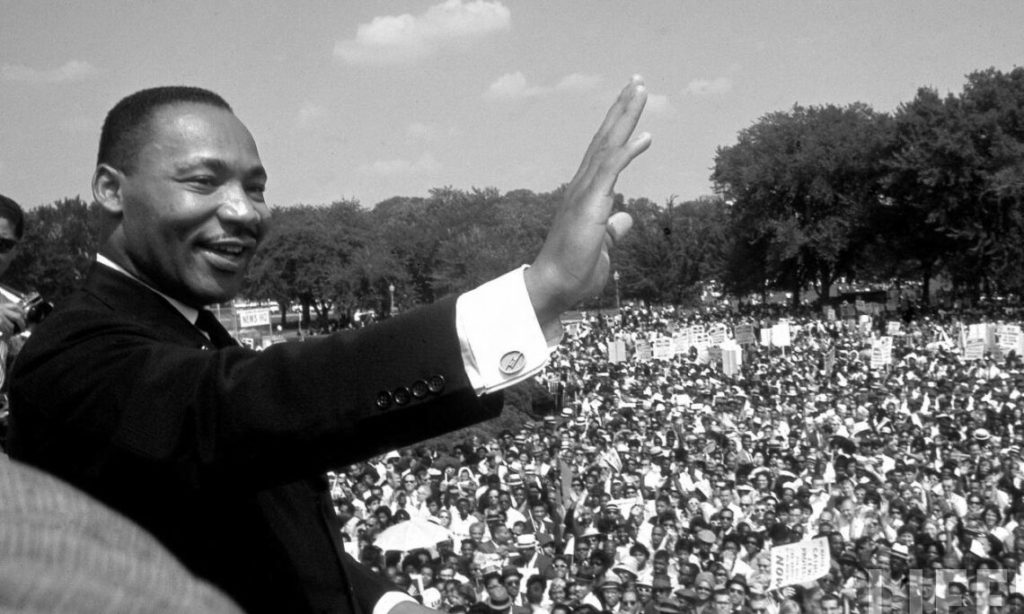 MLK waving to crowd.