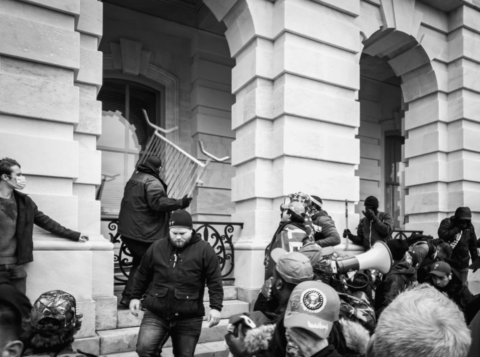 A rioter uses a piece of fencing as a weapon during the attack on the Capitol, Jan. 6, 2021.