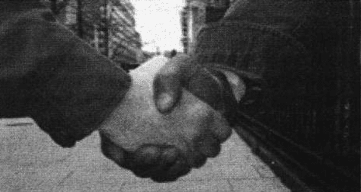 Two men shake hands