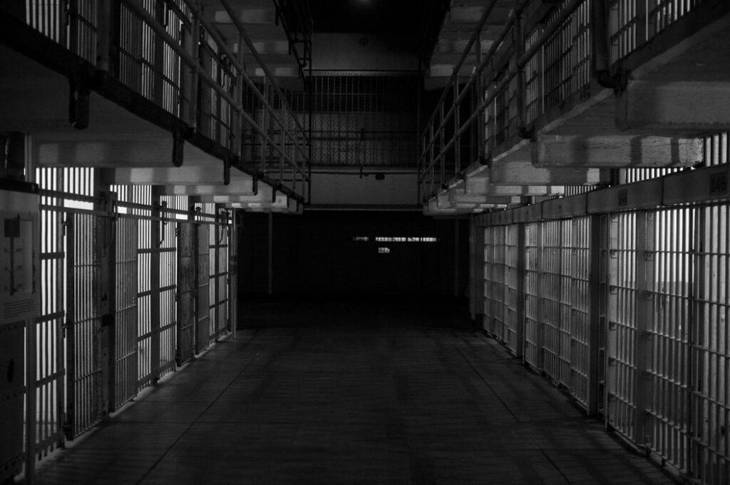 A black and white photo of the inside of a jail.