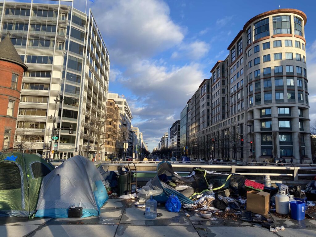 Picture shows an Encampment near Washington Circle Park, showing three tents and personal belongings.