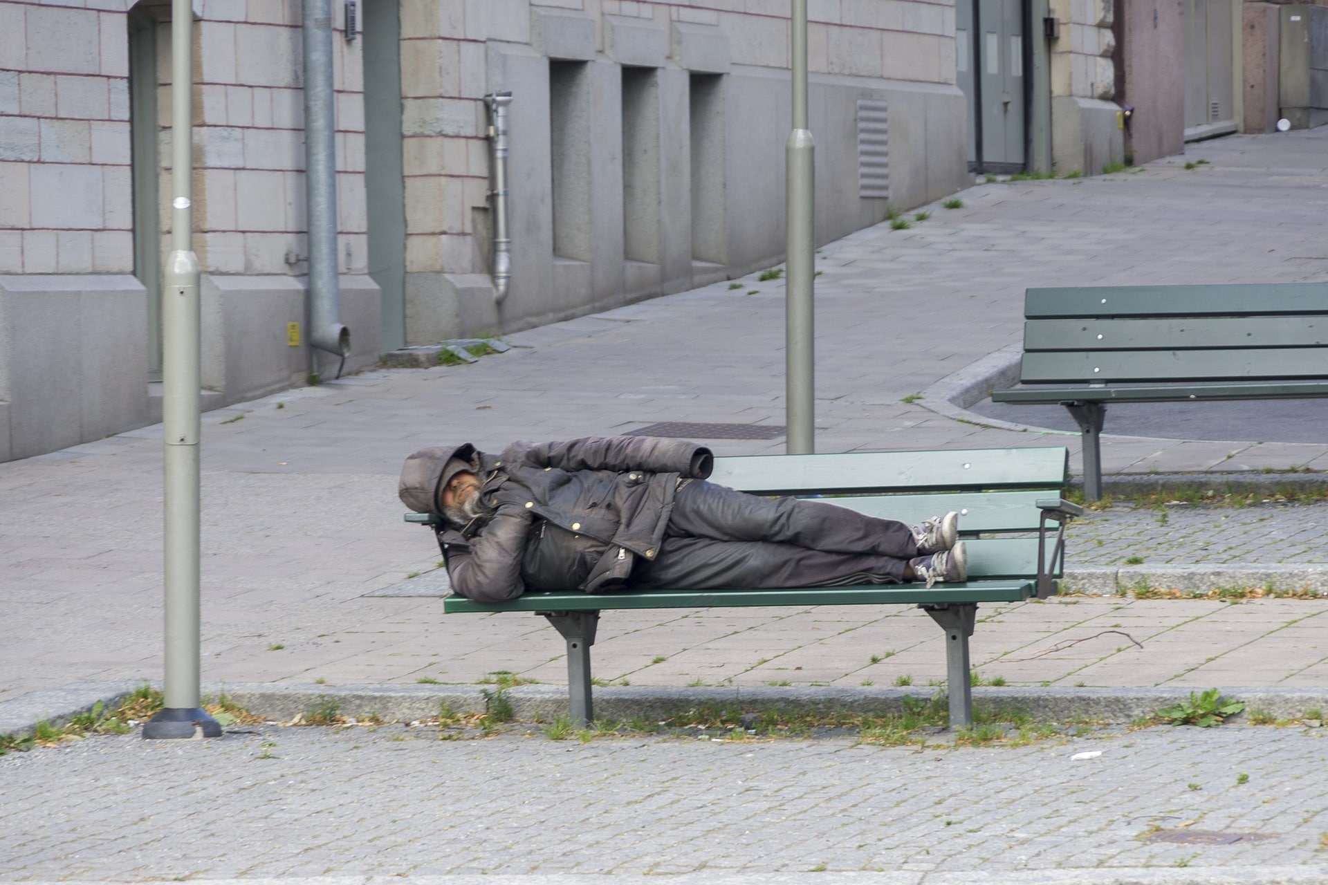 Photo of homeless man on bench.