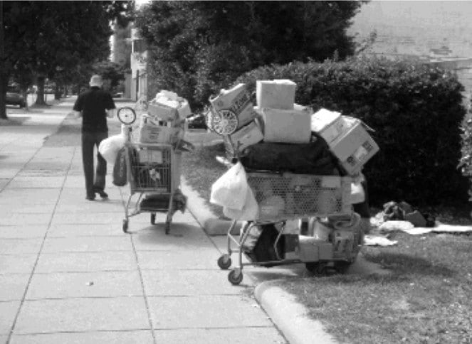 An image of belongings of a homeless person stored in shopping carts.