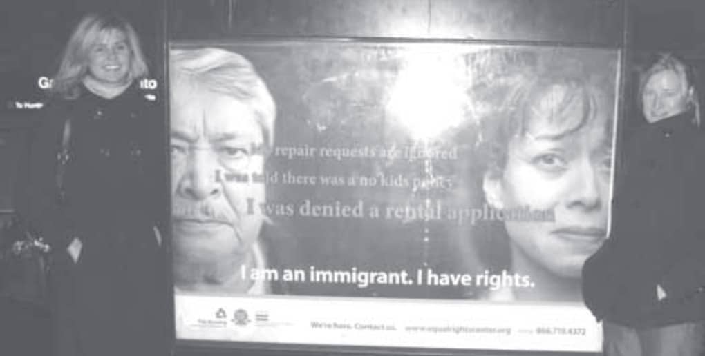 Image of two Equal Rights Center employees in front of an initiative launch poster.
