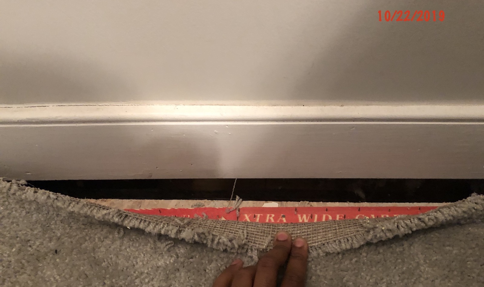 Photo depicting cracks in the floor of a condo.