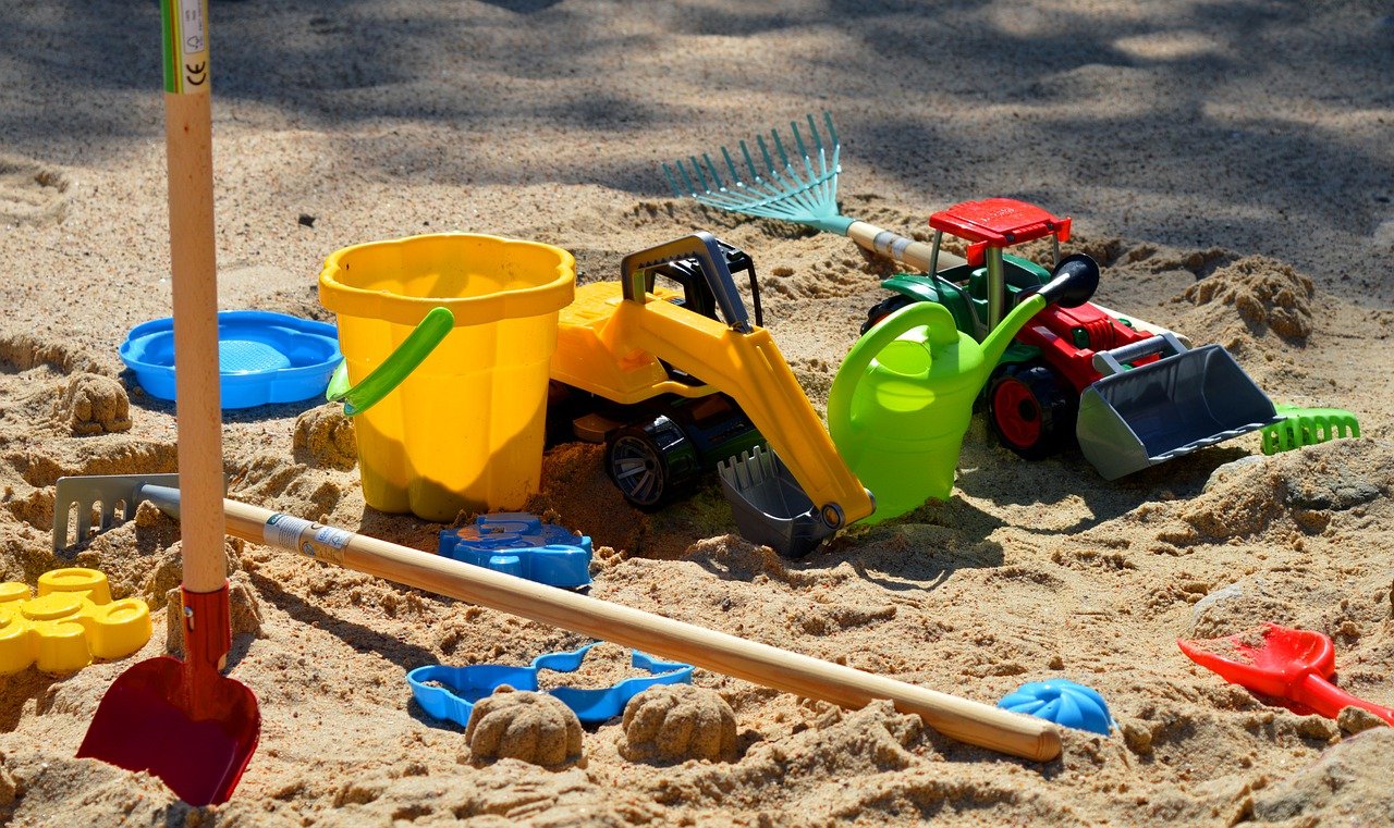 Picture of children's toys in a sandbox.