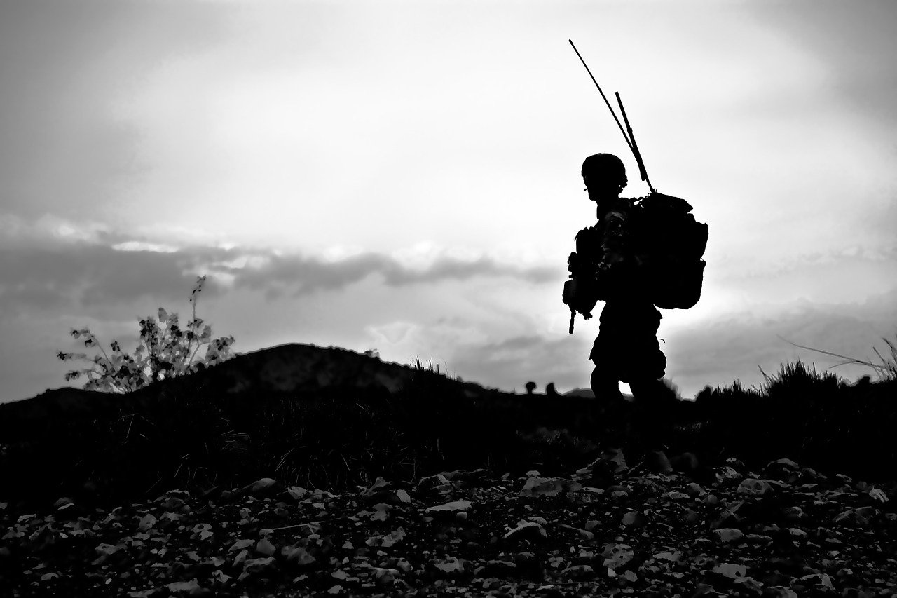 Image of a soldier walking in Afghanistan.