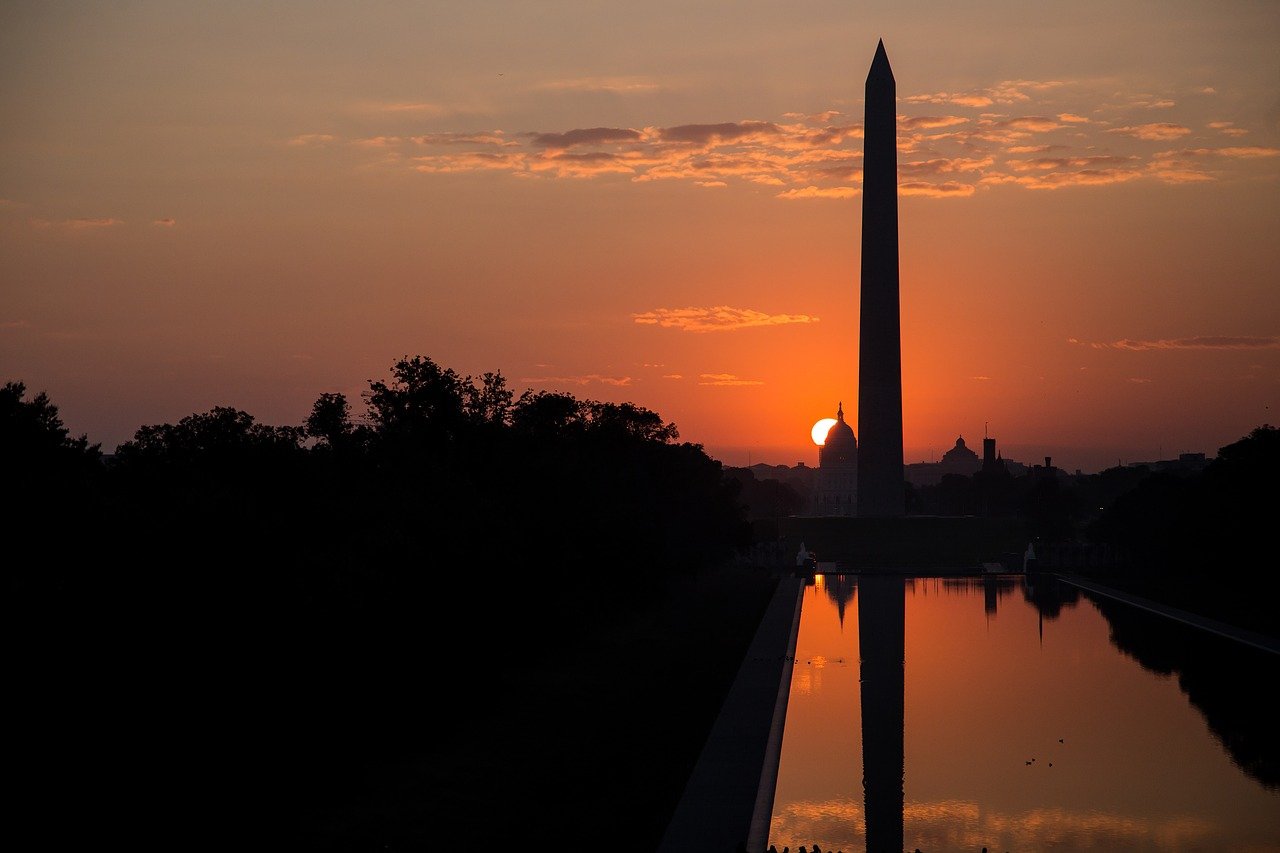 An image of Washington DC's skyline during a morning sunrise. The Washington Monument is prominent.
