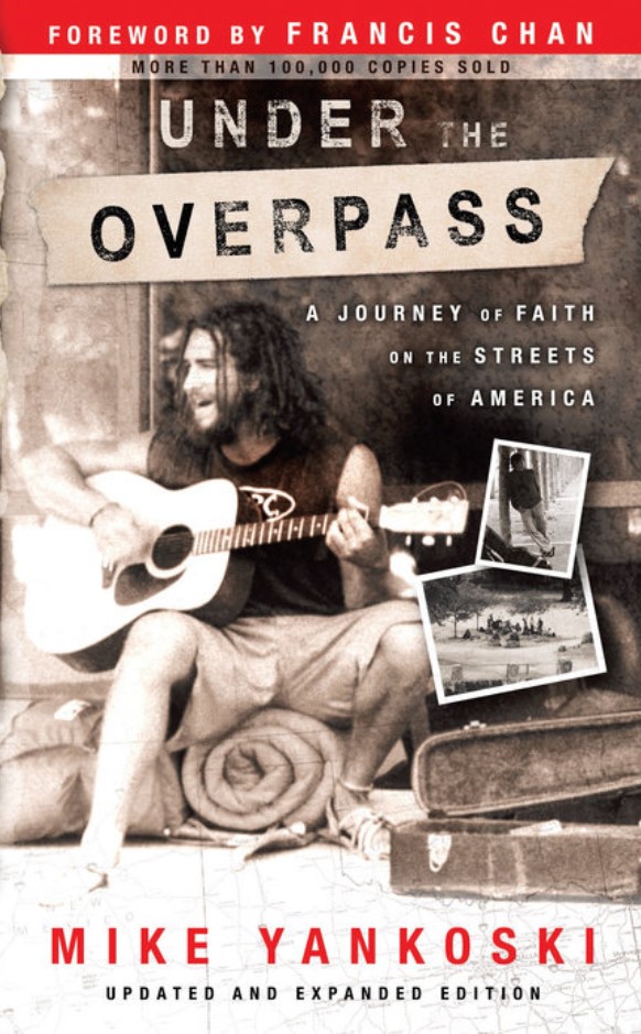 A photo of the cover of Under the Overpass, which depicts Yanoski sitting and playing a guitar.