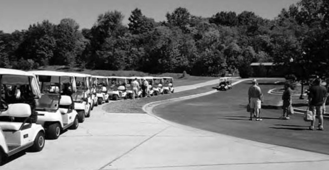 Photo of the Renditions Golf Course. A line of golf carts await players.
