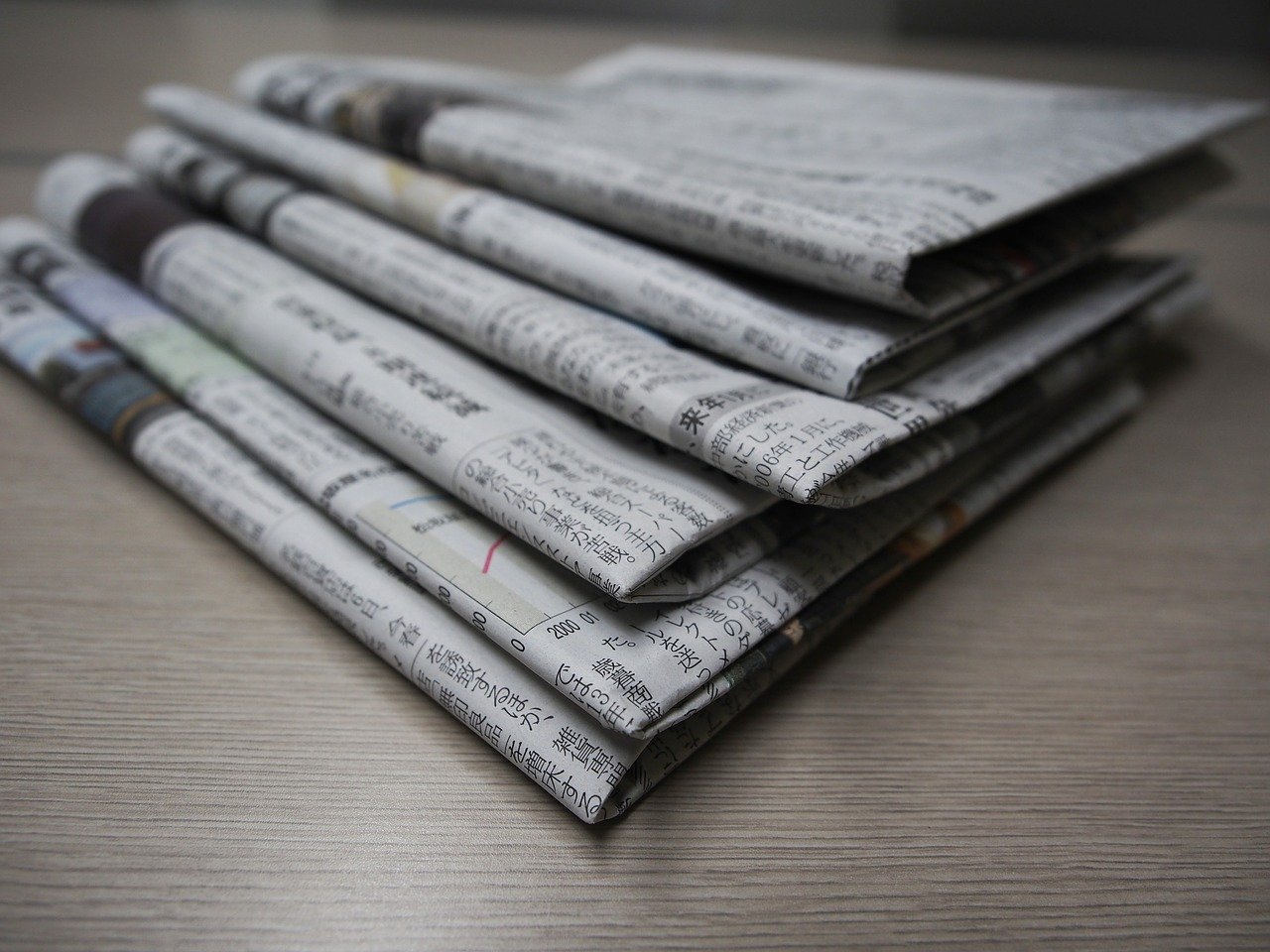 Image of folded and stacked newspapers.