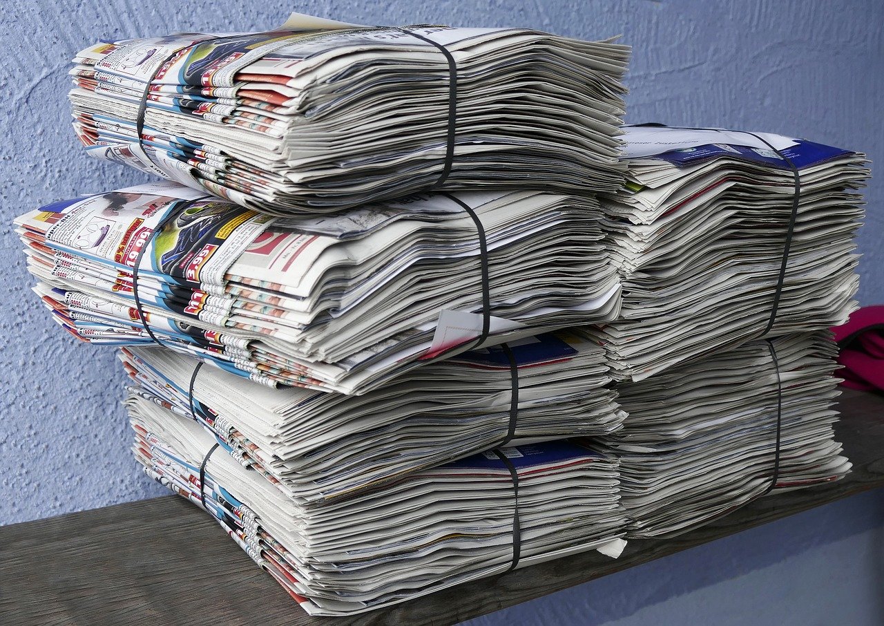 A photo of stacks of bound newspapers.