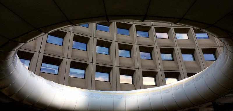 A photo of the Housing and Urban Development Department through an art structure.