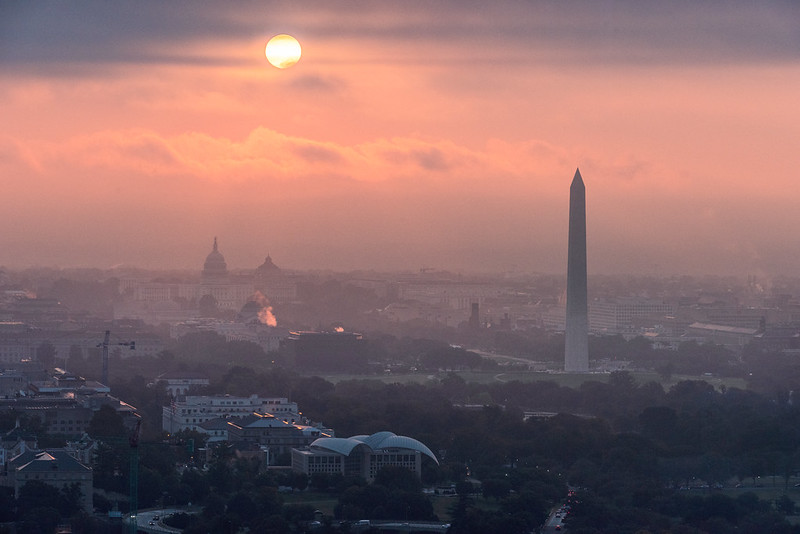 An aerial photo of Washington, DC, with emphasis on the National Mall, during a foggy sunrise.