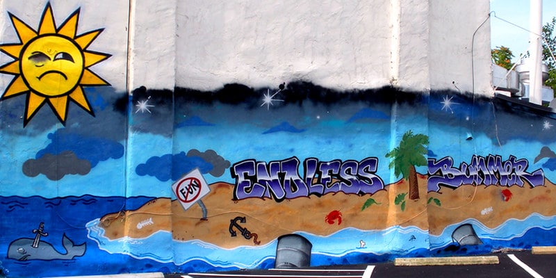 Photo of the "Endless Bummer" mural in DC. It shows a heavily polluted island full of trash.
