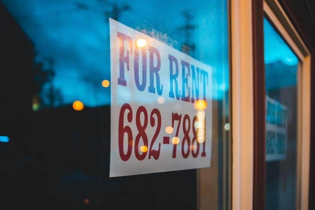 Photo of a "For Rent" sign in a window.