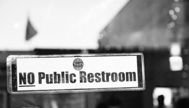 A photo of a restaurant with a sign that says "NO public restroom" on the front door