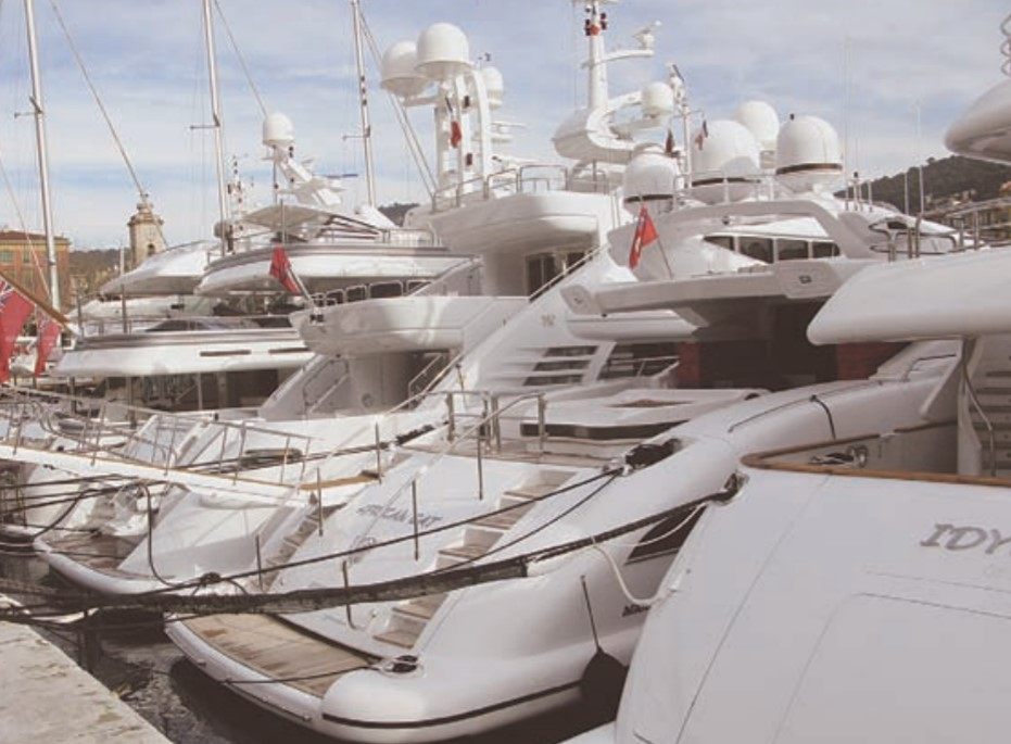 Photo of luxury yachts docked in Nice, France.