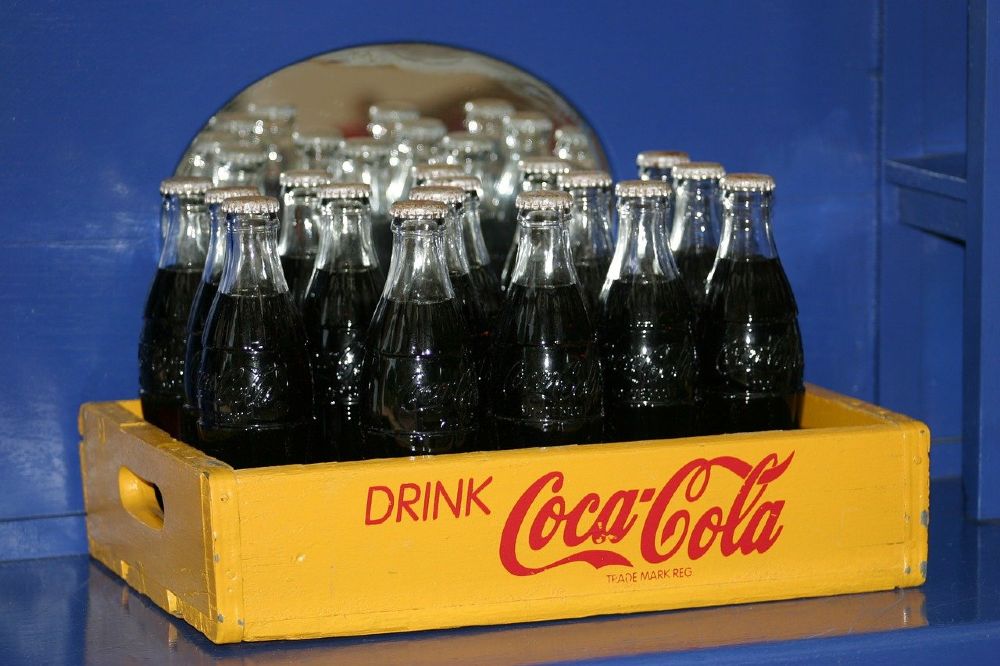 Photo of a case of glass Coke soda pop bottles.
