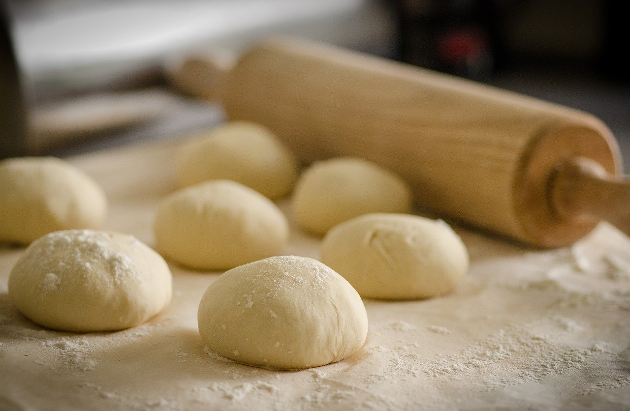 Photo of bread dough and baking supplies.