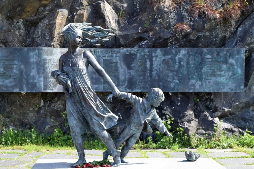 A photo of a statue of a mother and two children