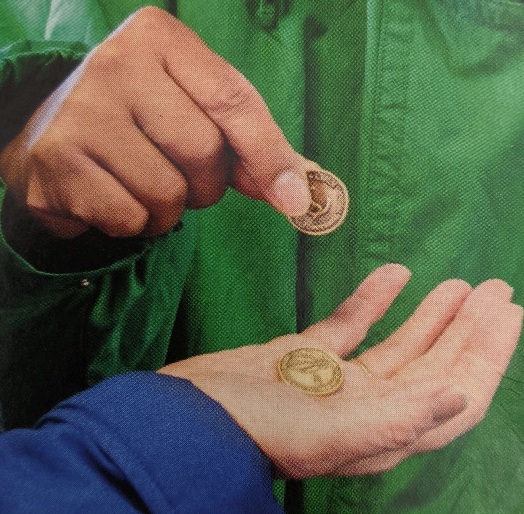 Photo of a person handing another person Breadcoins.