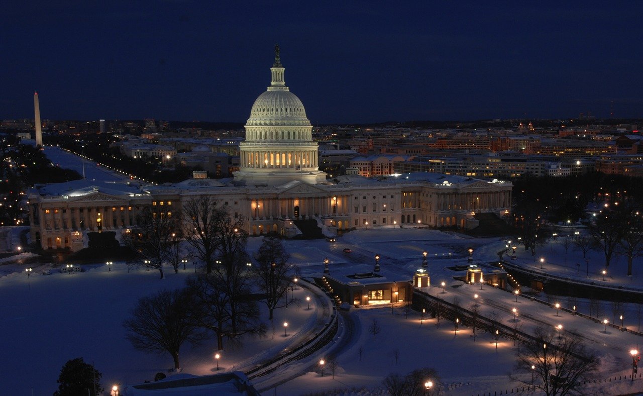 Photo of the U.S. Capitol at night time during winter