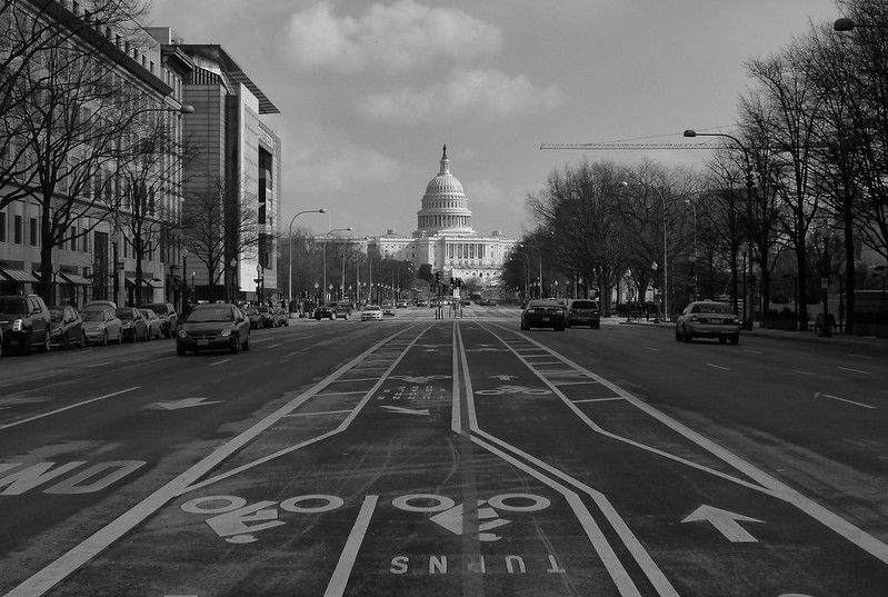 Black and white photo of the US Capitol from the middle of Penn Ave