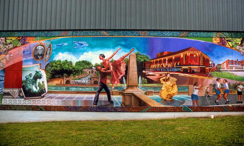 A mural with numerous images, most prominently a couple dancing in Meridian Hill Park