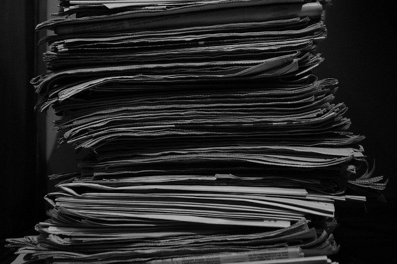 Photo of a stack of grey newspapers