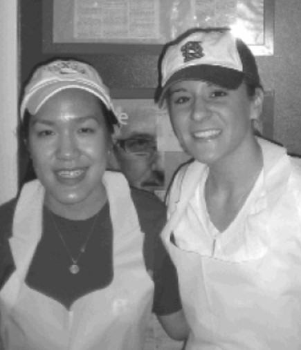 Alecia and a fellow student pose for a picture wearing aprons.