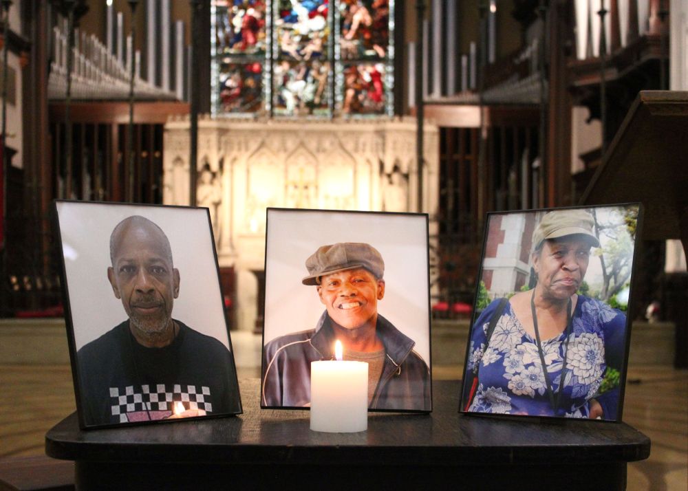 Photos of Dan Hooks, David Denny, and Shernell Thomas with a single candle lit in memorial.