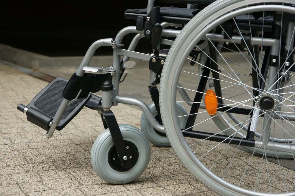 Photo of the lower half of a wheelchair