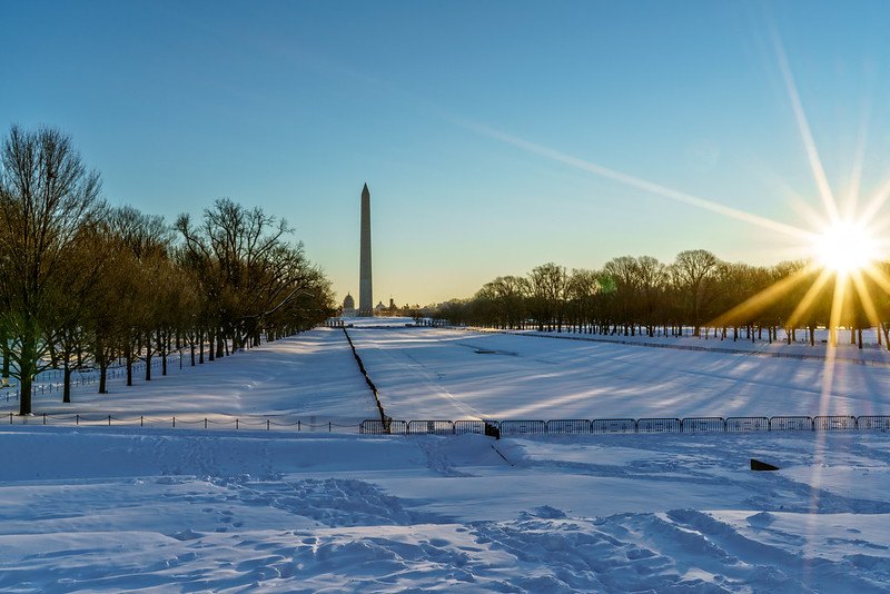 Photo of sunrise over the National Mall while it is covered in snow