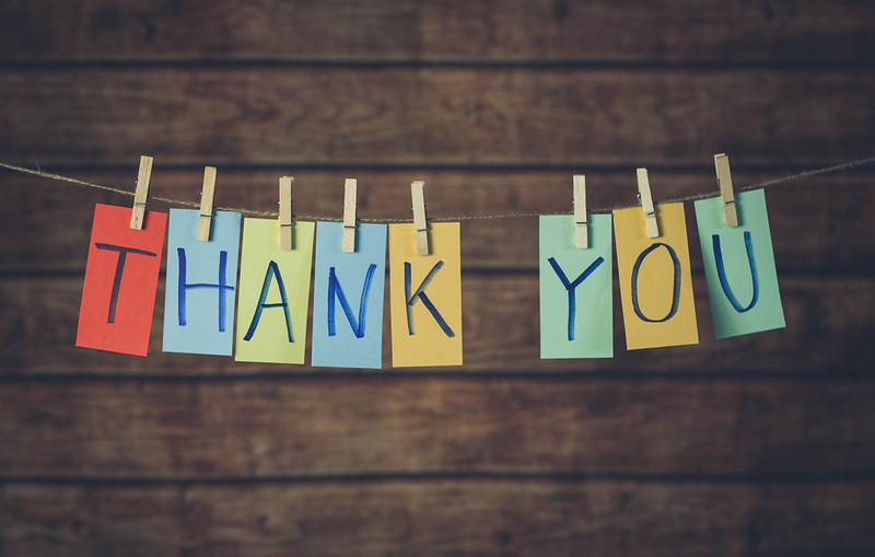 Stylized phot of "Thank You" written in individual notecards and hung on a clothesline