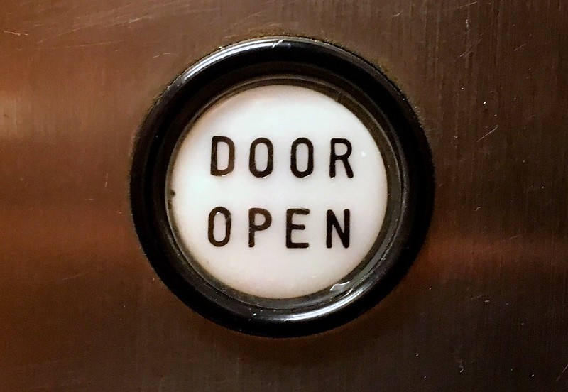 Photo of a "Door Open" button in an elevator
