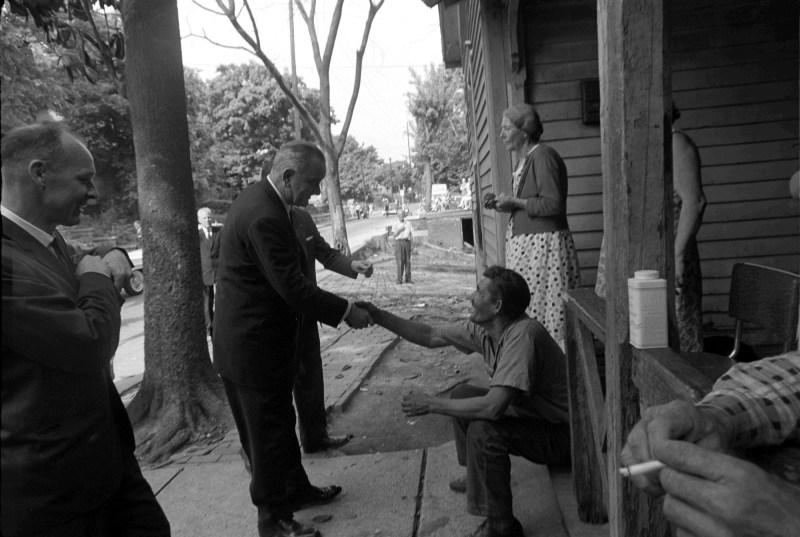 LBJ shakes the hand of a resident in this photo
