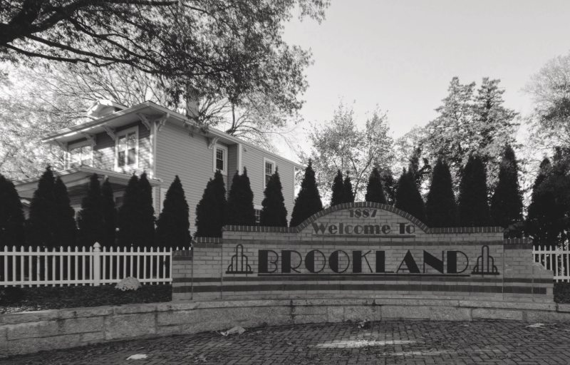 A brick welcome sign greats visitors arriving at Brookland