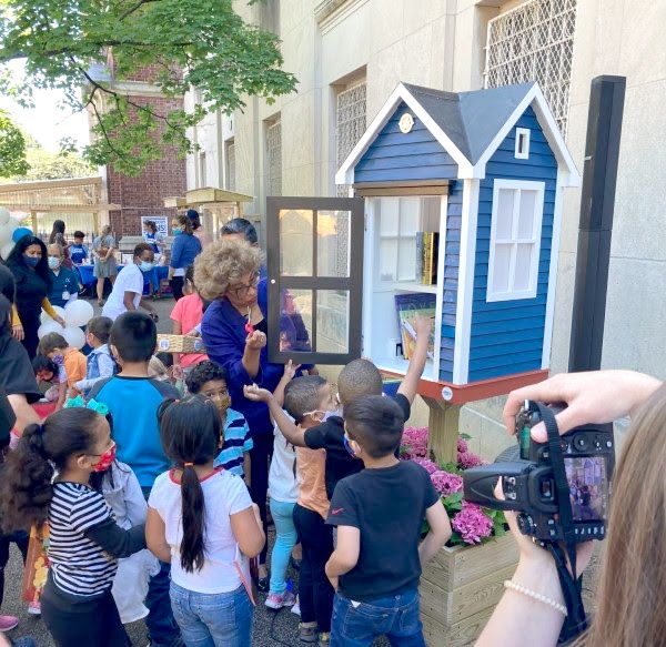 Photo of young children surrounding the new Little Free Library