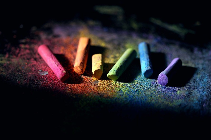 Photo of colorful chalk laying against a dark background