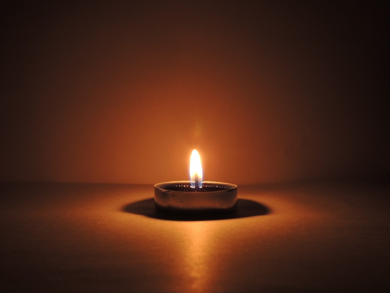 Photo of a single burning candle