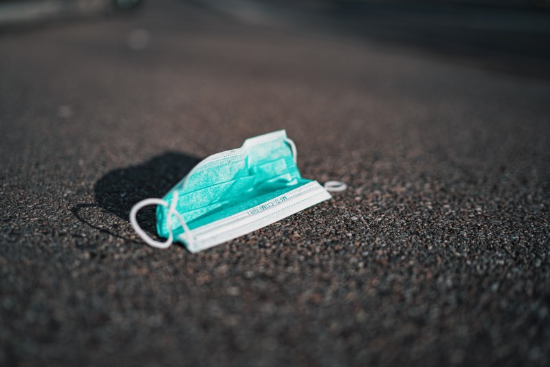 Photo of a disposable face mask lying on the ground