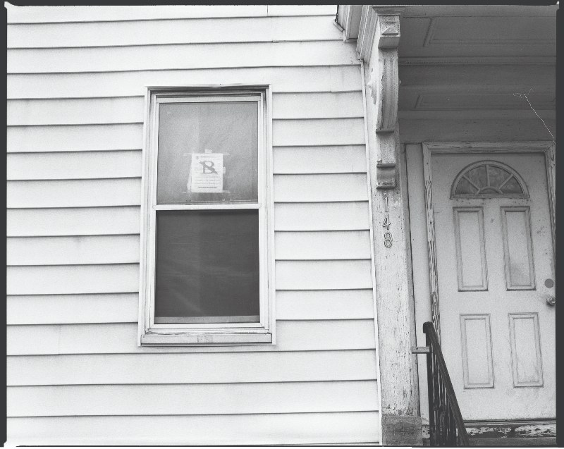 Photo of a house with an eviction notice posted