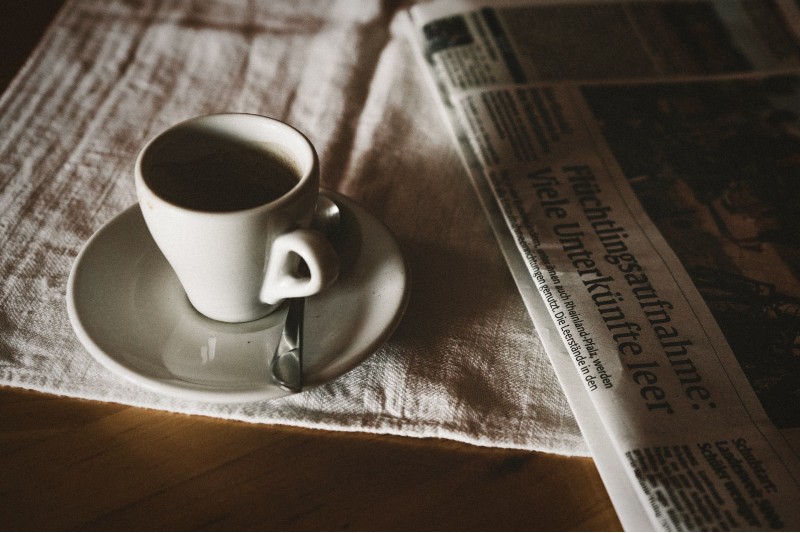 Photo of a cup of tea sitting on a newspaper